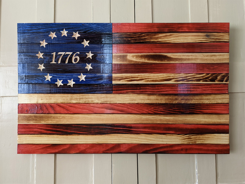 Wooden American Flag sign made from colored stained wood with a 1776 ring of stars in the blue field